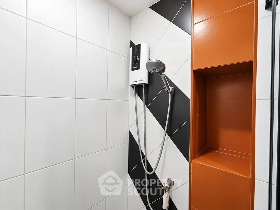 Modern bathroom with stylish shower and geometric tile design