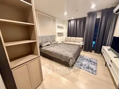 Modern bedroom with stylish decor, cozy bed, and elegant lighting in a contemporary apartment.