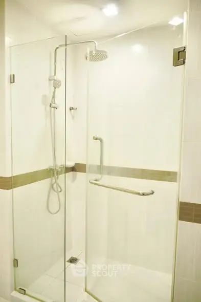 Modern bathroom with glass shower enclosure and sleek fixtures