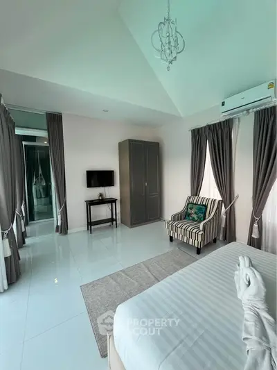 Elegant bedroom with modern decor, featuring a cozy armchair, sleek wardrobe, and stylish curtains.