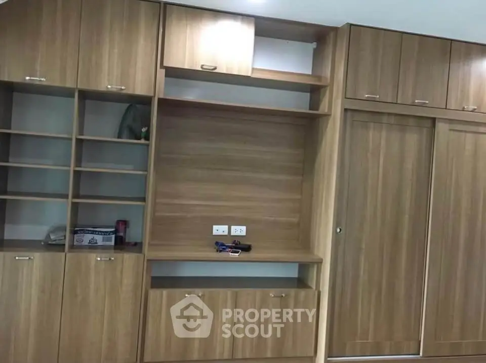 Spacious wooden built-in storage unit with ample shelving and cabinets