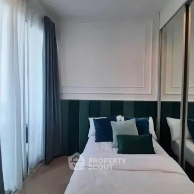 Cozy bedroom with stylish decor and mirrored wardrobe