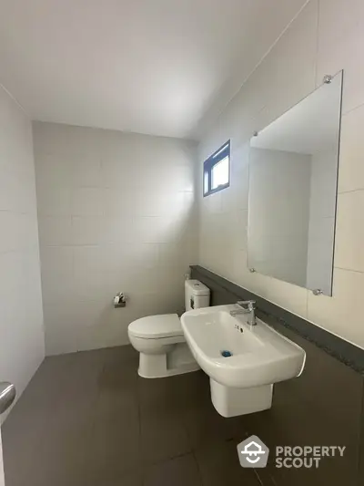 Modern minimalist bathroom with sleek fixtures and natural light