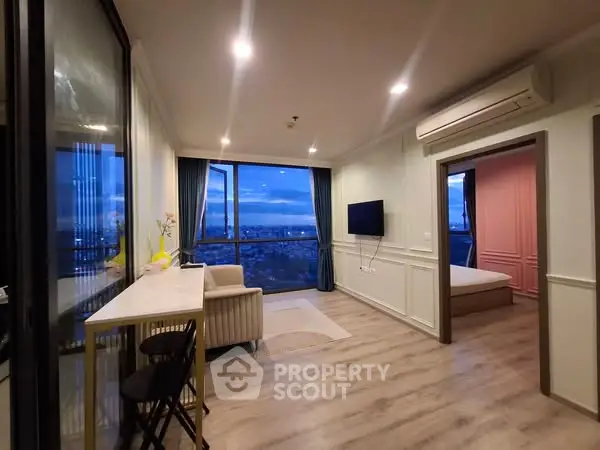 Modern living room with city view, sleek furniture, and ambient lighting in a high-rise apartment.