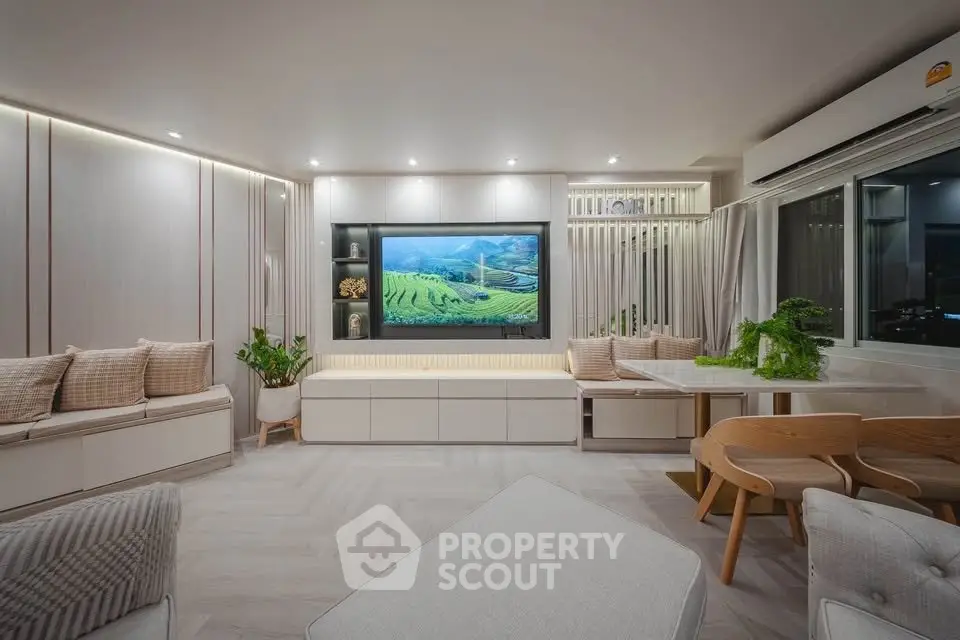 Modern living room with sleek design, built-in TV, and stylish furniture, perfect for relaxation and entertainment.