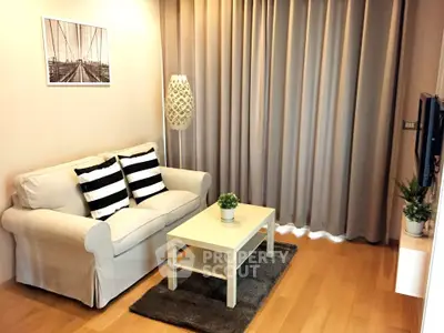 Cozy living room with stylish decor and natural light, featuring a comfortable sofa and modern furnishings.