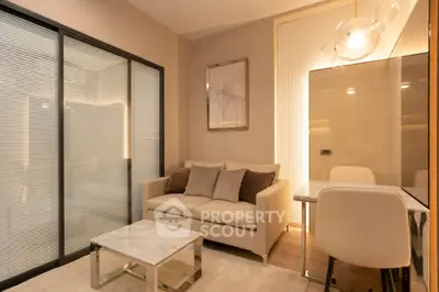 Modern living room with cozy sofa, elegant decor, and warm lighting