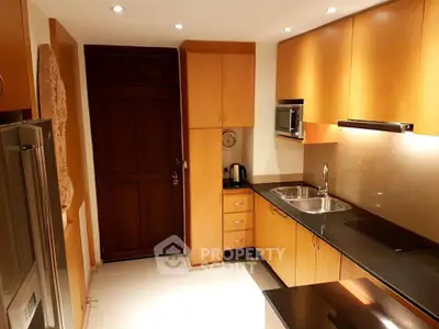 Modern kitchen with sleek wooden cabinets and stainless steel appliances