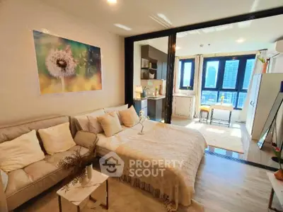 Chic studio apartment with cozy living area and city view, perfect for urban living.
