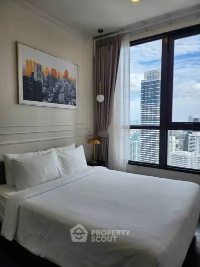 Luxurious bedroom with stunning city view and modern decor in high-rise apartment.