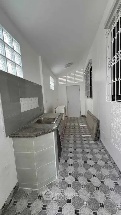 Charming kitchen with modern tile flooring and sleek countertops
