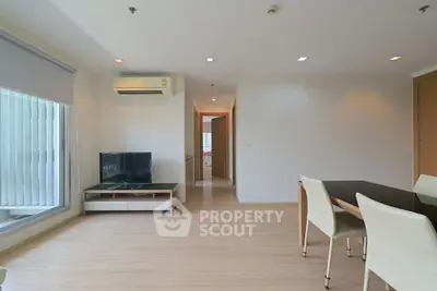 Modern living room with sleek furniture and natural light, perfect for relaxation and entertainment.