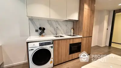 Modern kitchen with integrated appliances and sleek wooden cabinetry