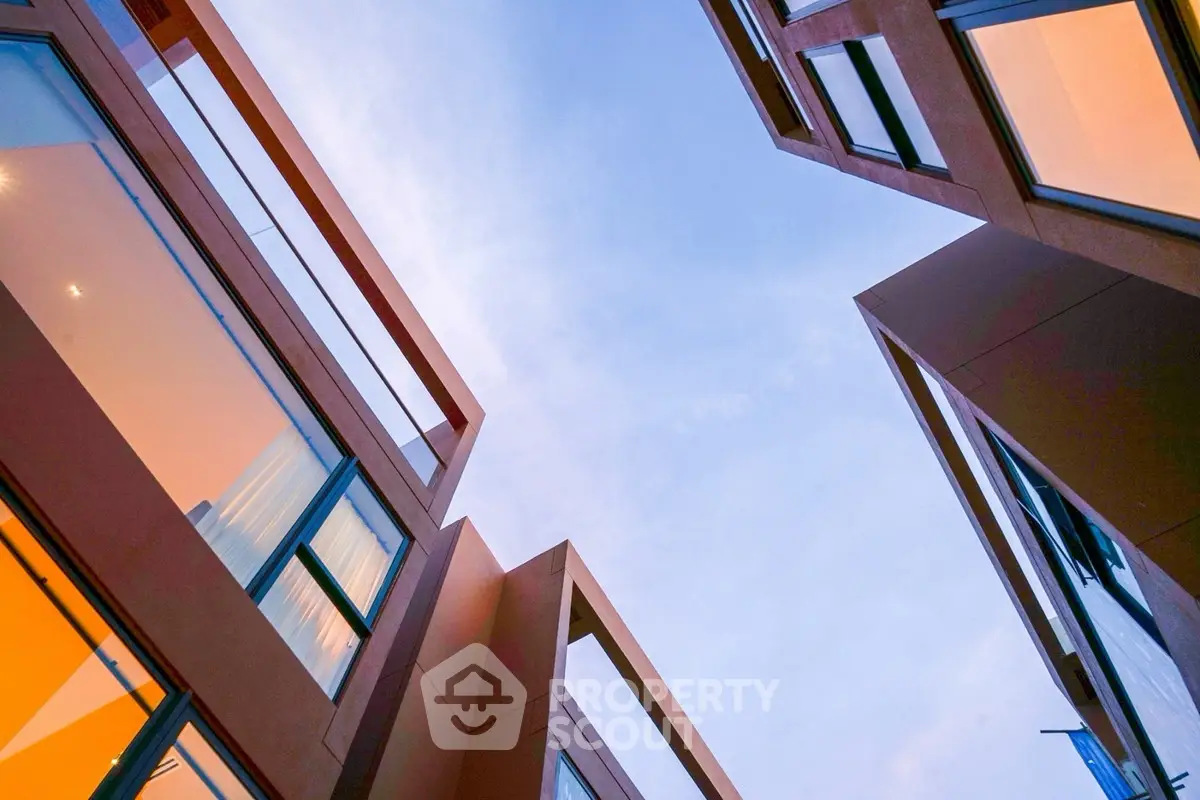 Modern architectural building exterior with unique angles and large windows.