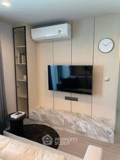 Modern living room with wall-mounted TV and air conditioning unit