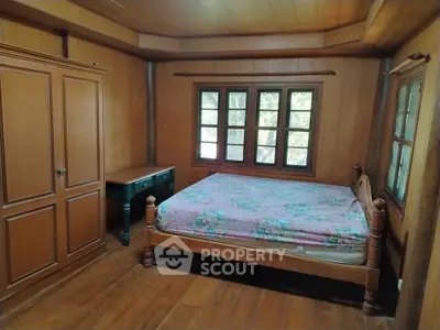 Cozy wooden bedroom with rustic charm and natural light