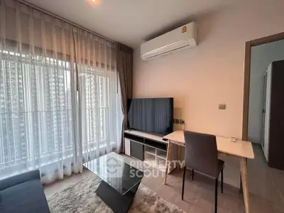 Modern living room with large window, air conditioning, and sleek furniture.