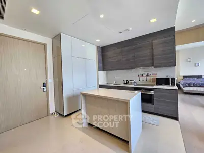 Modern open kitchen with sleek cabinetry and island in stylish apartment