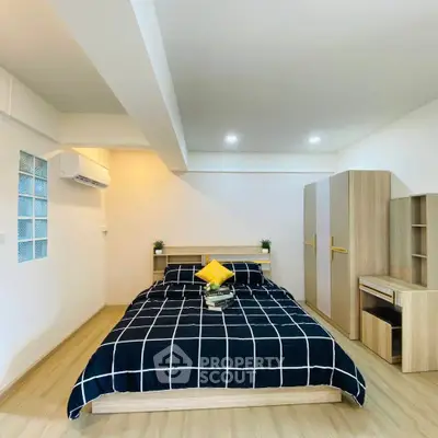 Modern bedroom with stylish decor and ample storage space