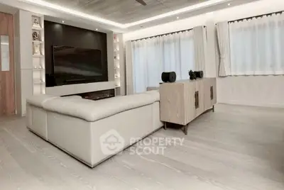 Spacious modern living room with sleek design and large windows for natural light.