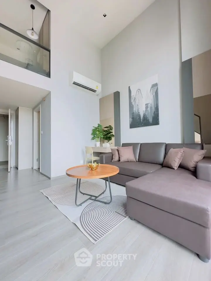 Modern living room with stylish decor and comfortable seating in a bright apartment.