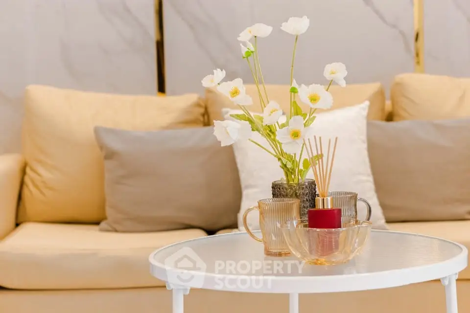Elegant living room with cozy beige sofa and stylish decor accents.