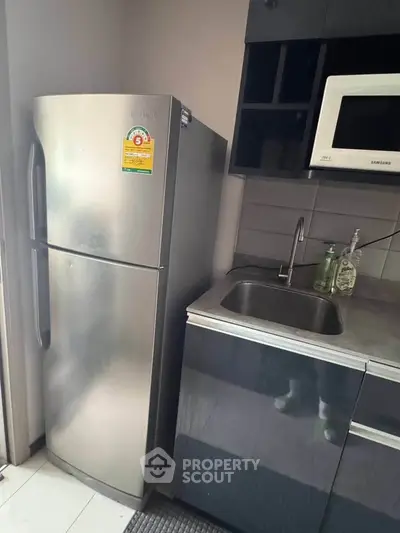 Modern kitchen with stainless steel fridge and sleek cabinetry