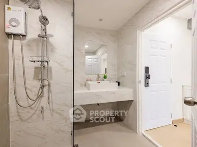 Modern bathroom with sleek design and spacious layout, featuring a shower and elegant vanity.