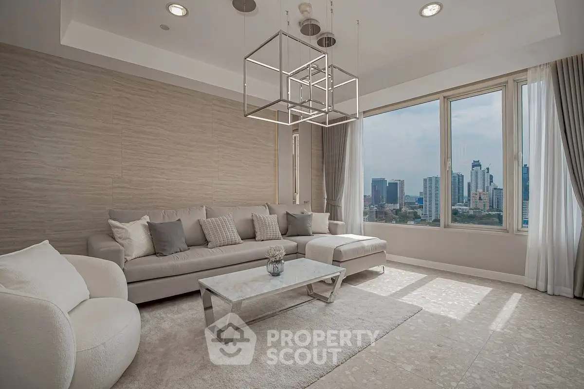 Luxurious living room with modern decor and stunning city view through large windows.