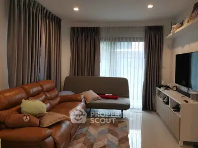 Cozy living room with leather sofa and modern entertainment setup