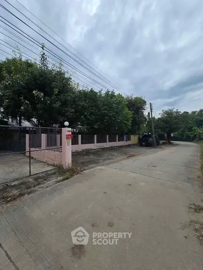 Charming suburban property with spacious driveway and lush greenery, perfect for serene living.