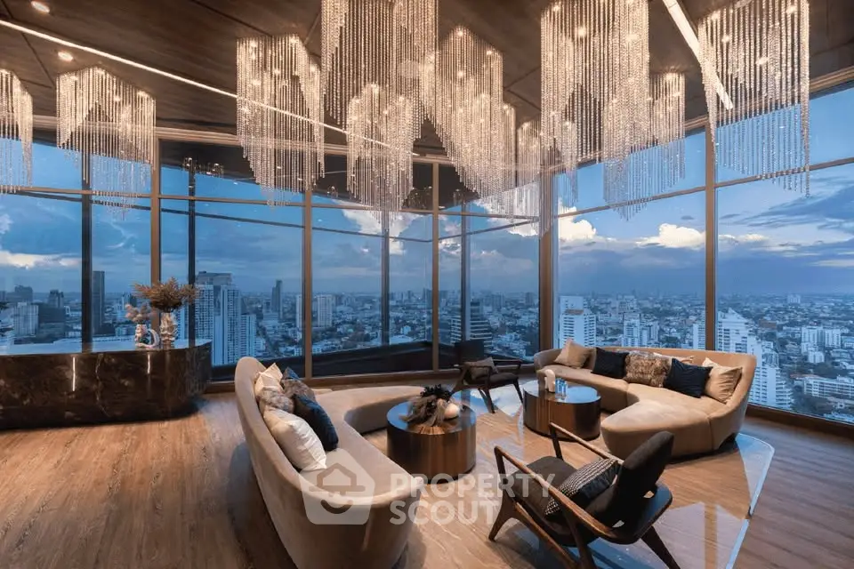 Luxurious living room with panoramic city view and elegant chandeliers in high-rise apartment.