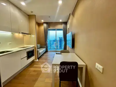 Modern studio apartment with open kitchen and city view balcony, featuring sleek design and cozy living space.