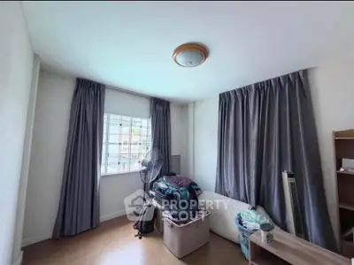 Cozy bedroom with natural light and ample storage space, perfect for urban living.