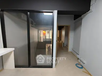 Modern interior hallway with sleek glass partition and minimalist design