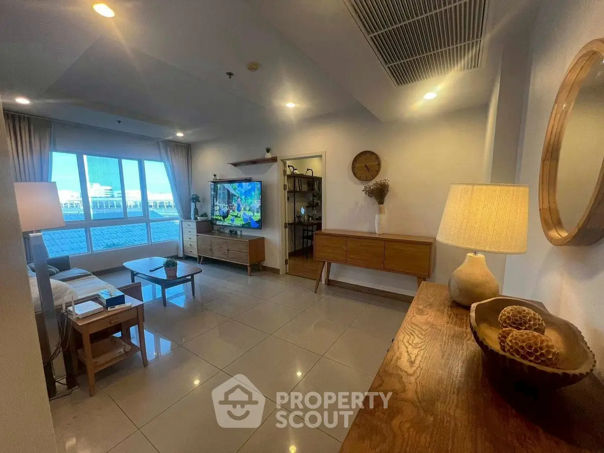 Spacious living room with modern decor and large windows offering a stunning view.