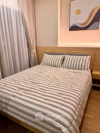 Cozy bedroom with stylish decor and natural light, perfect for relaxation and comfort.
