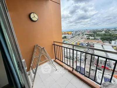 Spacious balcony with city view in high-rise apartment, perfect for relaxation and enjoying the skyline.