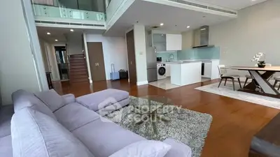 Spacious modern living room with open kitchen and stylish decor