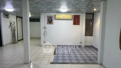 Spacious interior with tiled flooring and air conditioning, ideal for versatile use.