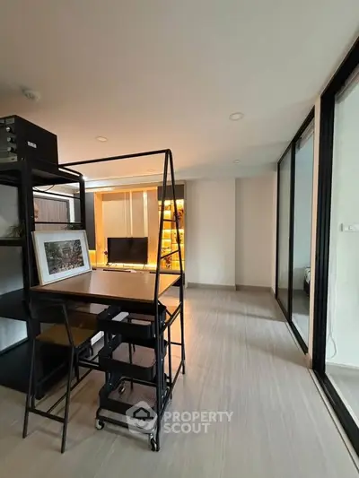 Modern living room with sleek furniture and large glass doors for natural light.