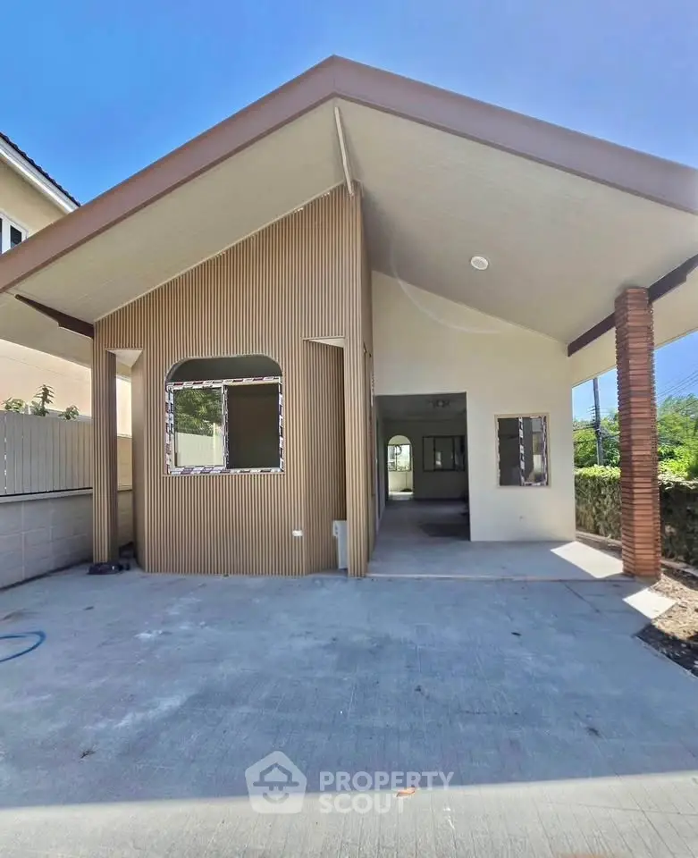 Modern single-story house with unique architectural design and spacious driveway, perfect for family living.