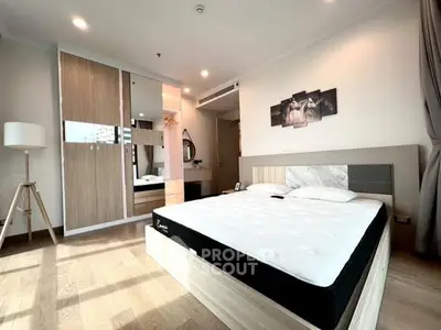 Spacious modern bedroom with stylish decor and ample natural light