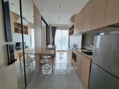 Modern open-layout kitchen and living room with sleek design and natural light.