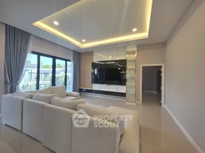Luxurious modern living room with elegant ceiling lights and large windows for natural light.