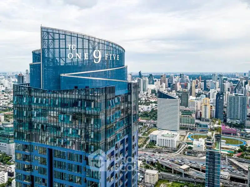 Stunning aerial view of a modern high-rise building in a bustling cityscape.