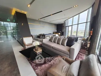 Luxurious modern living room with panoramic windows and elegant furnishings.