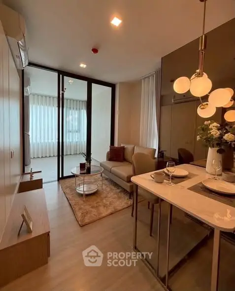 Modern living room with elegant decor and open layout, featuring cozy seating and stylish lighting.