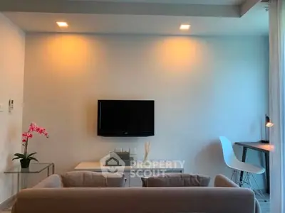 Modern living room with sleek TV setup and cozy seating area