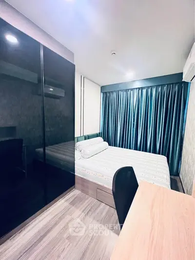 Modern bedroom with sleek black wardrobe and cozy bed